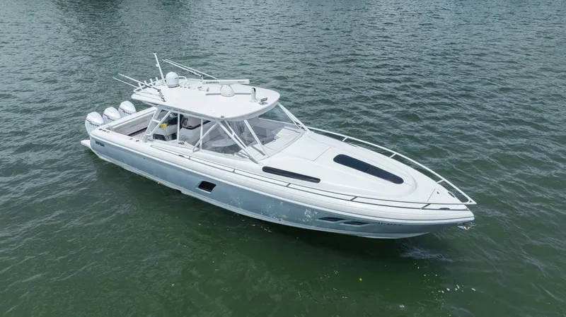 Slide: The Image of 2013 Intrepid 400 Cuddy boat on calm water, showcasing sleek design and modern features. - 10