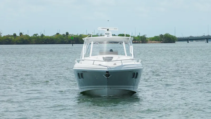 Slide: The Image of 2013 Intrepid 400 Cuddy boat on calm water, front view. - 12