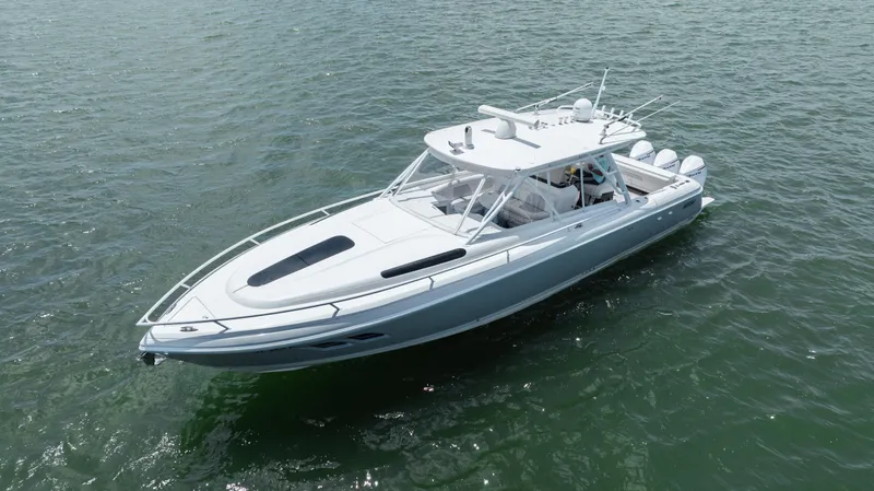 Slide: The Image of 2013 Intrepid 400 Cuddy boat cruising on open water. - 14