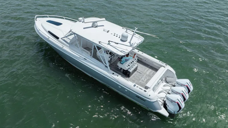 Slide: The Image of 2013 Intrepid 400 Cuddy boat with triple outboard engines on open water. - 15