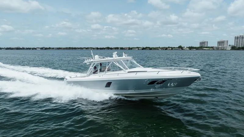 Slide: The Image of 2013 Intrepid 400 Cuddy cruising on open water under a partly cloudy sky. - 16