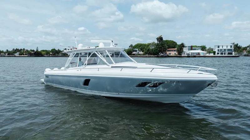 Slide: The Image of 2013 Intrepid 400 Cuddy boat on calm water, showcasing sleek design and modern features. - 3