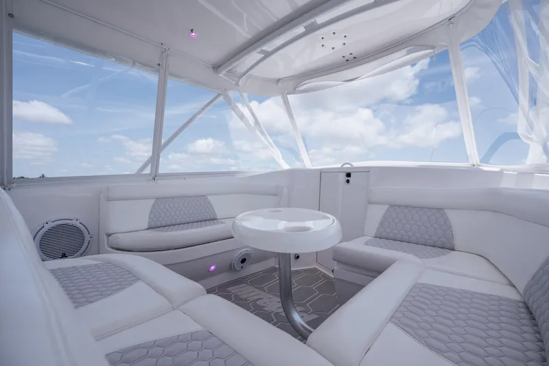 Slide: The Image of Luxurious interior of 2013 Intrepid 400 Cuddy boat with white seating and table. - 34