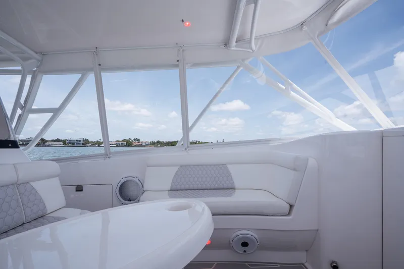 Slide: The Image of 2013 Intrepid 400 Cuddy interior with white seating and ocean view. - 35