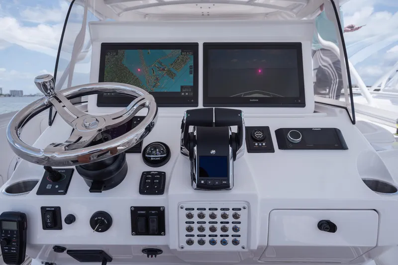 Slide: The Image of Control panel of a 2013 Intrepid 400 Cuddy boat with navigation screens. - 38