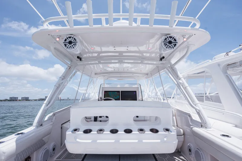 Slide: The Image of 2013 Intrepid 400 Cuddy boat interior with helm, ocean view, and clear sky. - 45