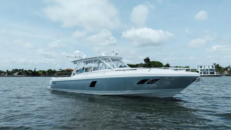 Slide: The Image of 2013 Intrepid 400 Cuddy boat on calm water under a partly cloudy sky. - 6