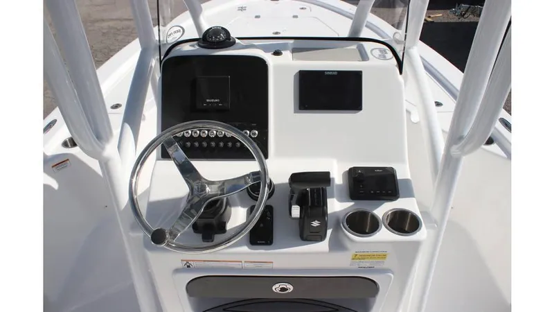 Slide: The Image of 2025 Sea Pro 210 boat console with steering wheel, controls, and cup holders. - 12