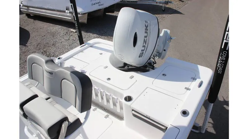 Slide: The Image of 2025 Sea Pro 210 boat with Suzuki outboard motor, featuring sleek seating and storage compartments. - 15