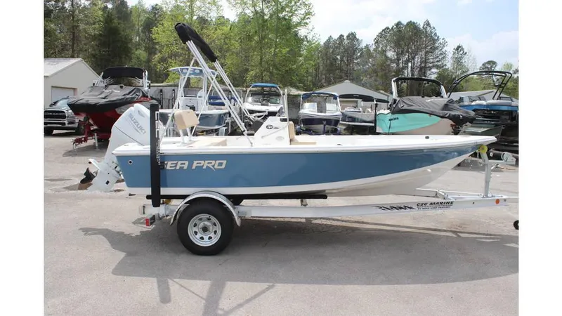 Slide: The Image of 2025 Sea Pro 172 boat on trailer, parked outdoors with other boats. - 5