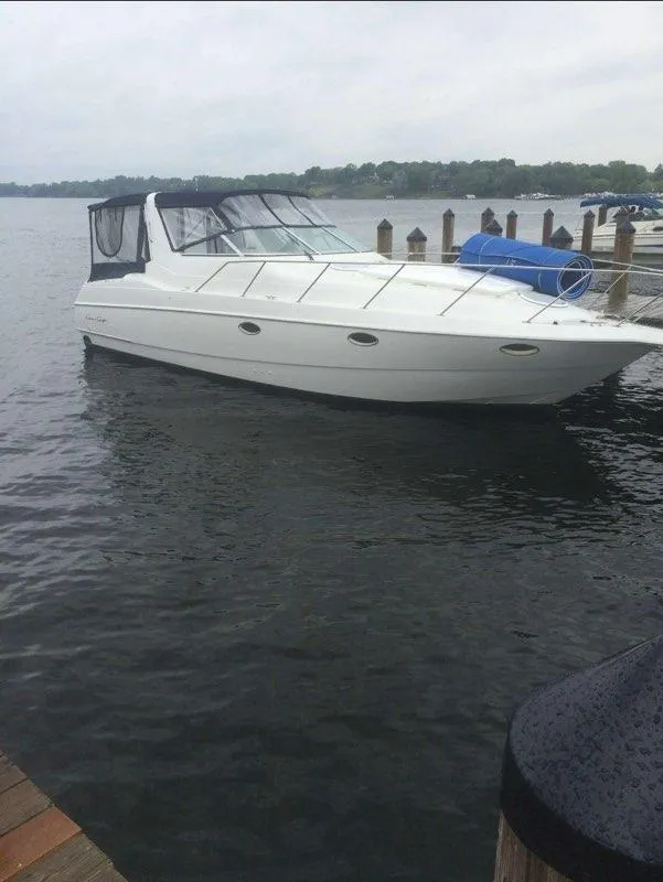 Slide: The Image of 1994 Chris-Craft 340 Crowne boat docked on a calm lake. - 11