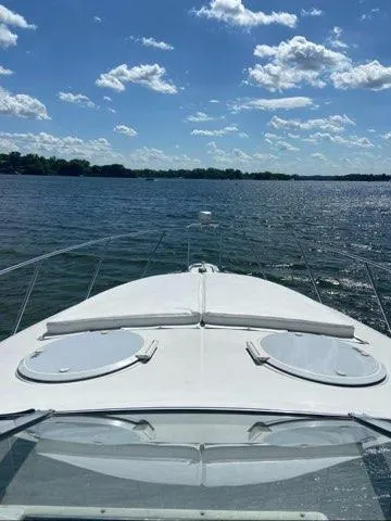 Slide: The Image of 1994 Chris-Craft 340 Crowne boat cruising on a sunny lake with clear skies. - 14
