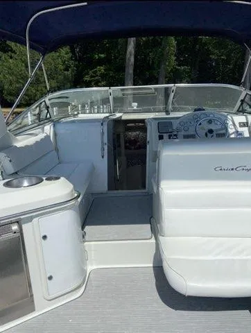 Slide: The Image of 1994 Chris-Craft 340 Crowne boat interior with white seating and steering area. - 16