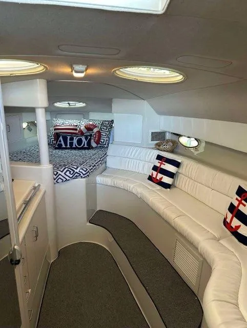 Slide: The Image of 1994 Chris-Craft 340 Crowne cabin interior with nautical-themed decor and cozy seating. - 5