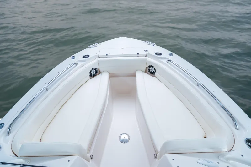 Slide: The Image of 2025 Grady-White Freedom 255 boat bow with white seating on calm water. - 6