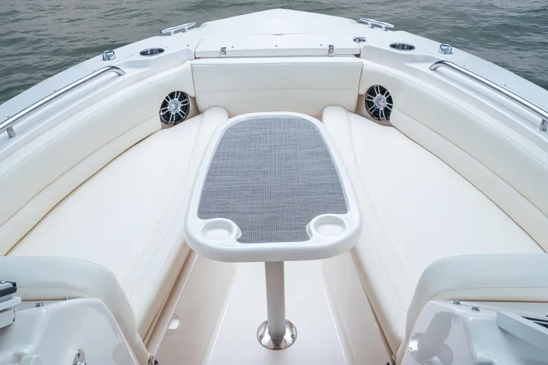 Slide: The Image of 2025 Grady-White Freedom 255 boat interior with seating and table on calm water. - 7
