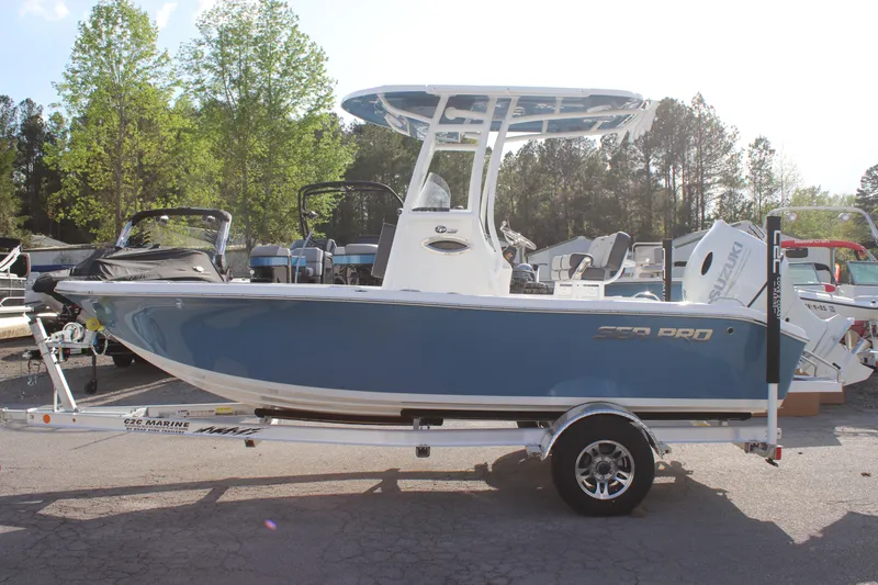 Slide: The Image of 2025 Sea Pro 202 CC boat on trailer, blue hull, parked outdoors. - 3