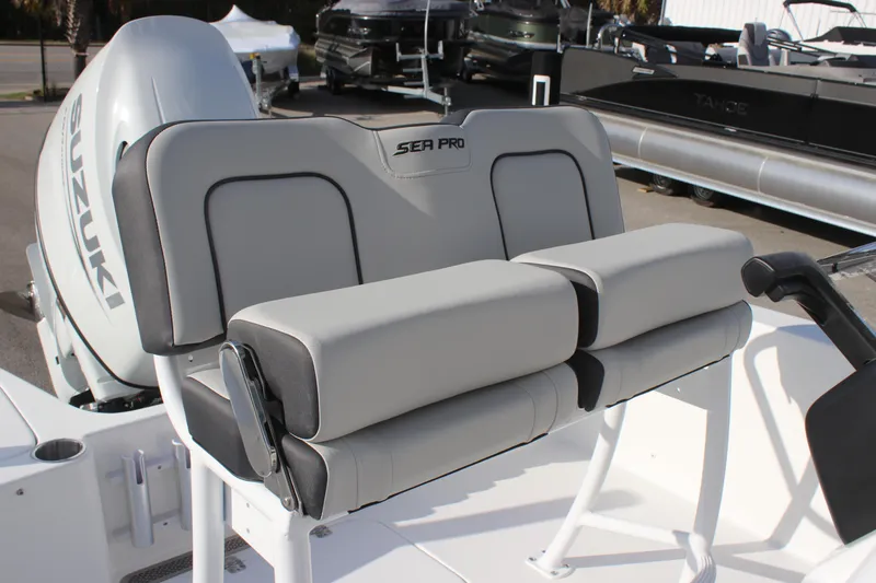 Slide: The Image of 2025 Sea Pro 202 CC boat seating with Suzuki engine in a marina setting. - 9