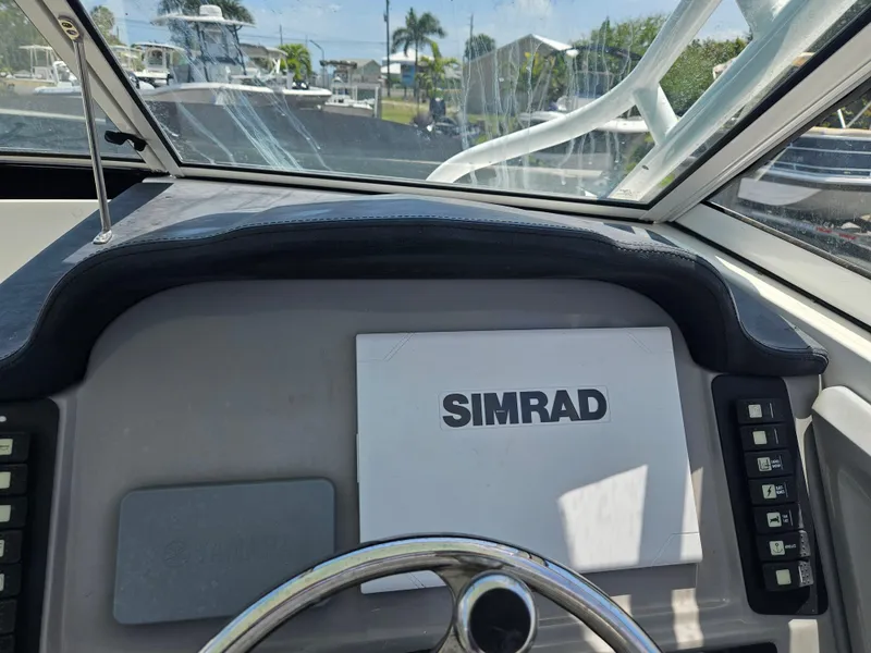 The Image of 2015 Robalo R247 Dual Console boat on trailer, parked outdoors. - 18