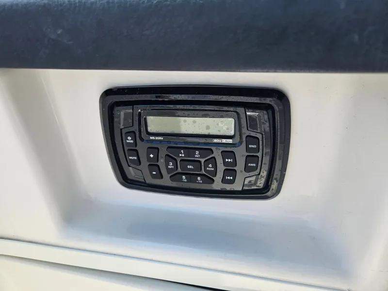 Slide: The Image of 2015 Robalo R247 Dual Console boat with powerful outboard motor, rear view. - 20