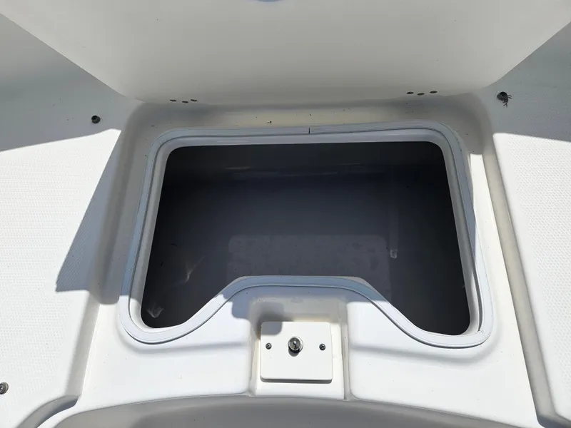 Slide: The Image of 2015 Robalo R247 Dual Console boat interior with white seating and steering wheel. - 27