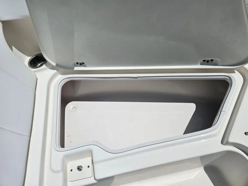 Slide: The Image of 2015 Robalo R247 Dual Console boat cockpit with steering wheel and control panel. - 28