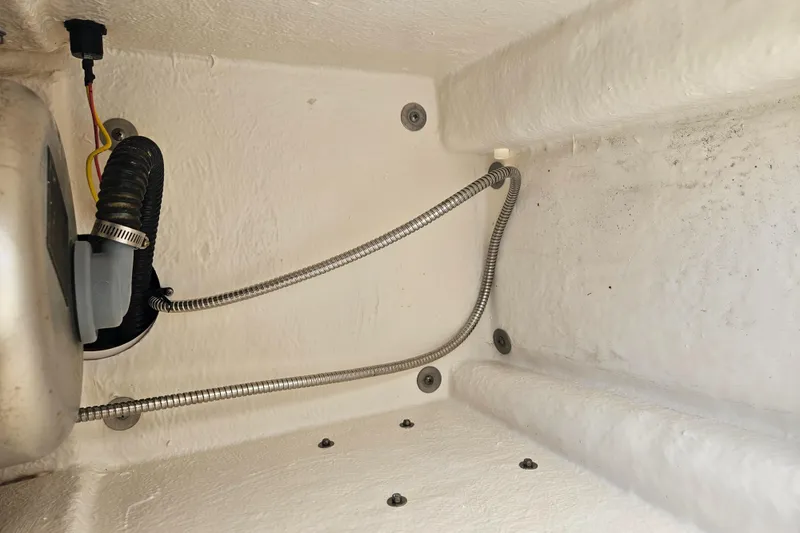 Slide: The Image of 2015 Robalo R247 Dual Console boat interior with toilet and mirror. - 29