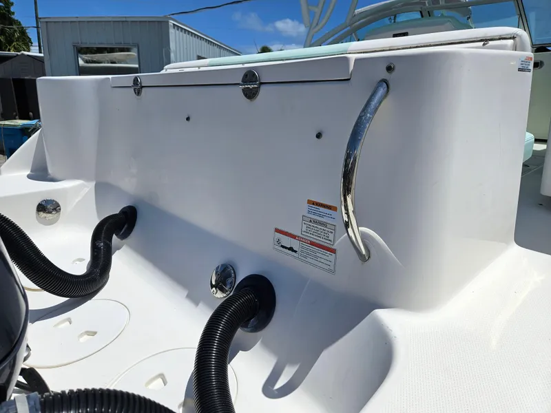 Slide: The Image of 2015 Robalo R247 Dual Console boat with spacious seating and sleek design. - 30