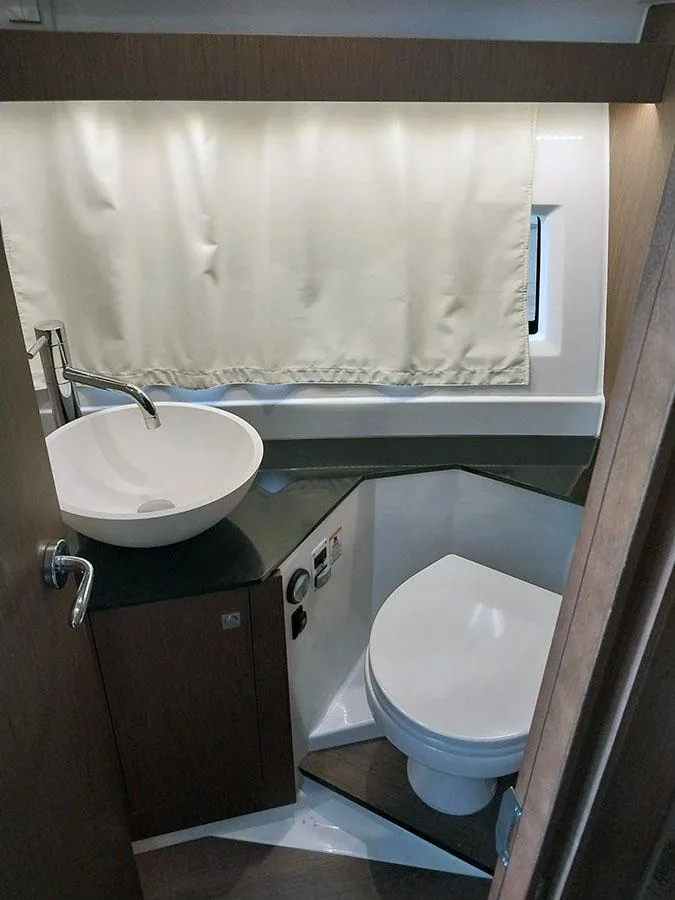 Slide: The Image of 2023 Jeanneau NC 1095 Fly bathroom with modern sink and toilet. - 10