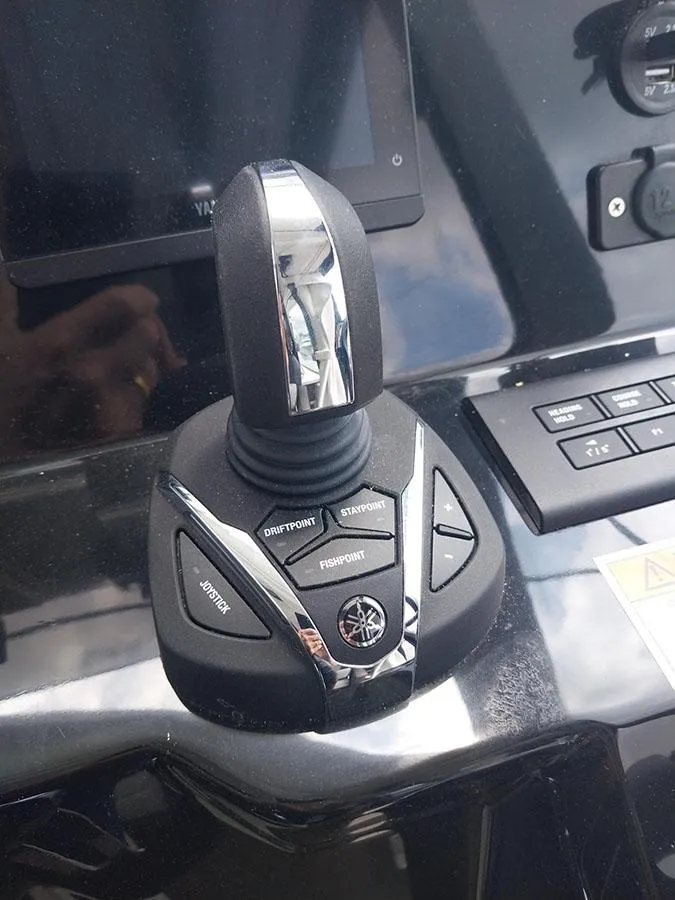 Slide: The Image of Joystick control on 2023 Jeanneau NC 1095 Fly boat dashboard. - 15