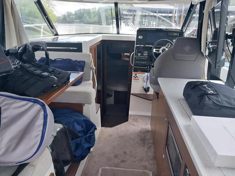 Slide: The Image of 2023 Jeanneau NC 1095 Fly interior with helm, seating, and storage. - 17