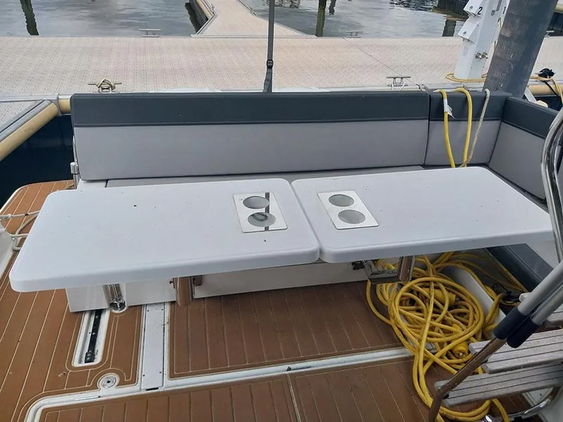 Slide: The Image of 2023 Jeanneau NC 1095 Fly boat deck with seating and table, dockside view. - 19
