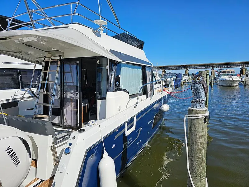 Slide: The Image of 2023 Jeanneau NC 1095 Fly yacht docked at marina with Yamaha engine. - 2