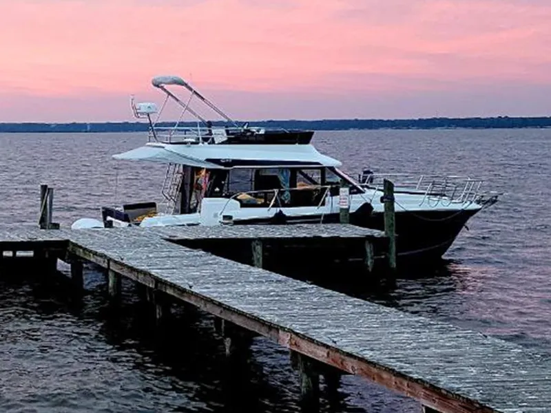 Slide: The Image of 2023 Jeanneau NC 1095 Fly moored at dock during sunset. - 3