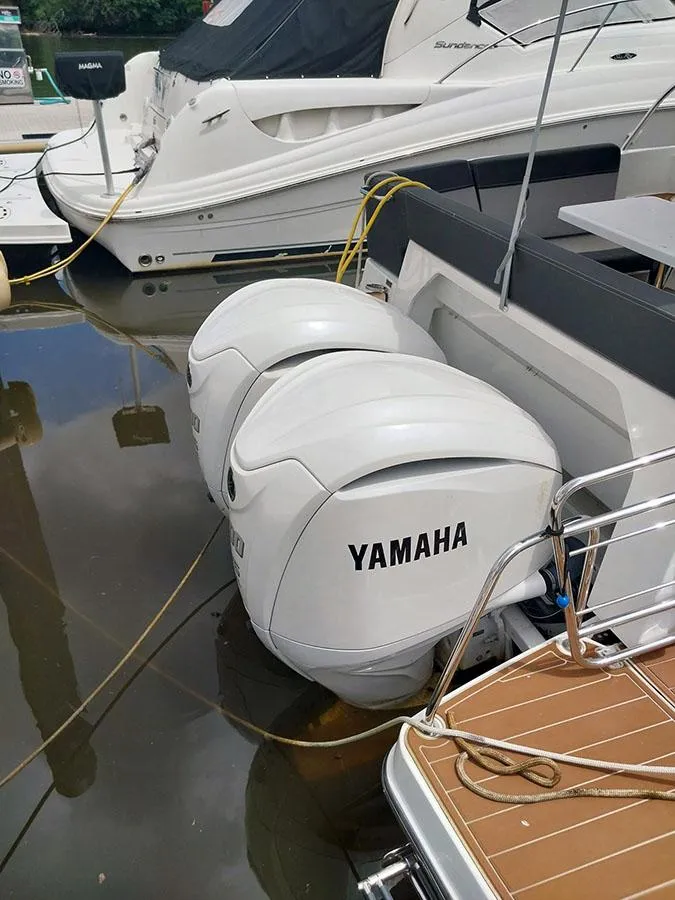 Slide: The Image of 2023 Jeanneau NC 1095 Fly with Yamaha outboard motors docked at marina. - 7