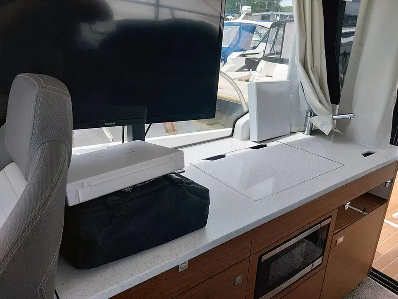 Slide: The Image of Interior of 2023 Jeanneau NC 1095 Fly with modern kitchen and seating area. - 8