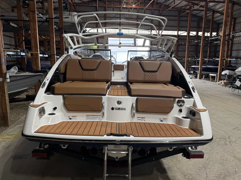 Slide: The Image of 2025 Yamaha Boats 252SD in a warehouse, showcasing rear seating and deck design. - 3