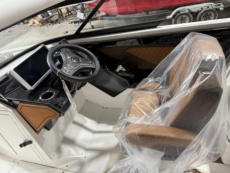 Slide: The Image of 2025 Yamaha Boats 252SD interior with steering wheel and covered seat. - 5