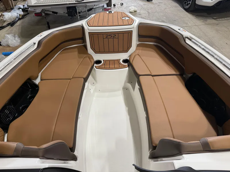 Slide: The Image of 2025 Yamaha Boats 252SD interior with tan seating and wood accents. - 6