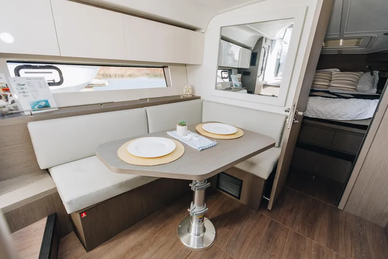 Slide: The Image of 2023 Beneteau Gran Turismo 41 interior with dining area and cozy cabin. - 11