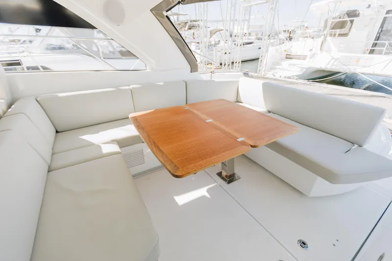 Slide: The Image of 2023 Beneteau Gran Turismo 41 yacht interior with elegant seating and wooden table. - 5