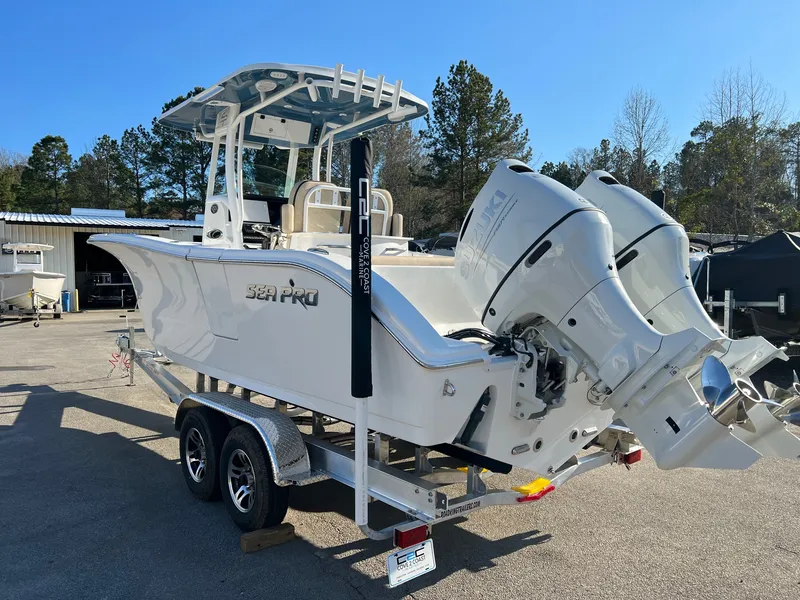 Slide: The Image of 2022 Sea Pro 259 Deep V Series CC boat on trailer with dual outboard engines. - 10