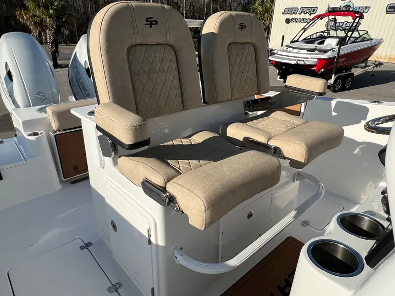 Slide: The Image of 2022 Sea Pro 259 Deep V Series CC boat with dual cushioned seats and cup holders. - 11