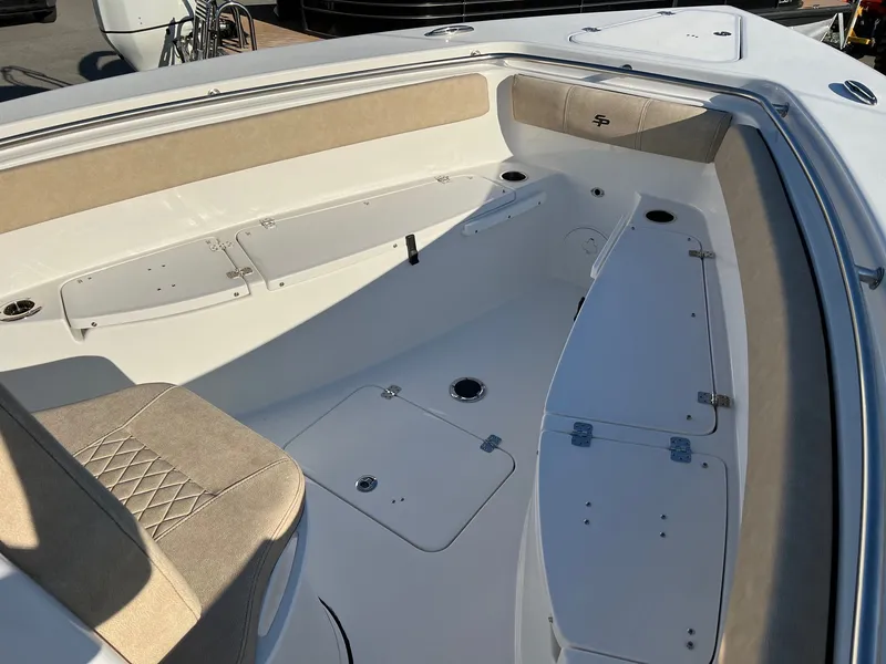 Slide: The Image of 2022 Sea Pro 259 Deep V Series CC boat interior with cushioned seating and storage compartments. - 12