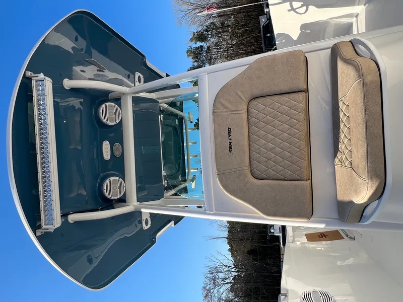 Slide: The Image of 2022 Sea Pro 259 Deep V Series CC boat interior with cushioned seating and overhead console. - 14