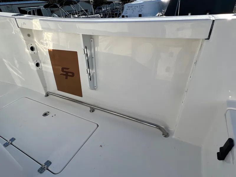 Slide: The Image of 2022 Sea Pro 259 Deep V Series CC boat interior with storage compartment and railing. - 15