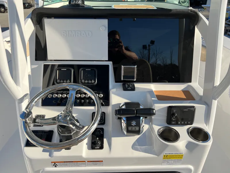 Slide: The Image of Control panel of 2022 Sea Pro 259 Deep V Series CC boat with steering wheel and electronics. - 18