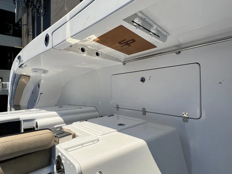 Slide: The Image of 2022 Sea Pro 259 Deep V Series CC boat interior with storage compartments and seating. - 2