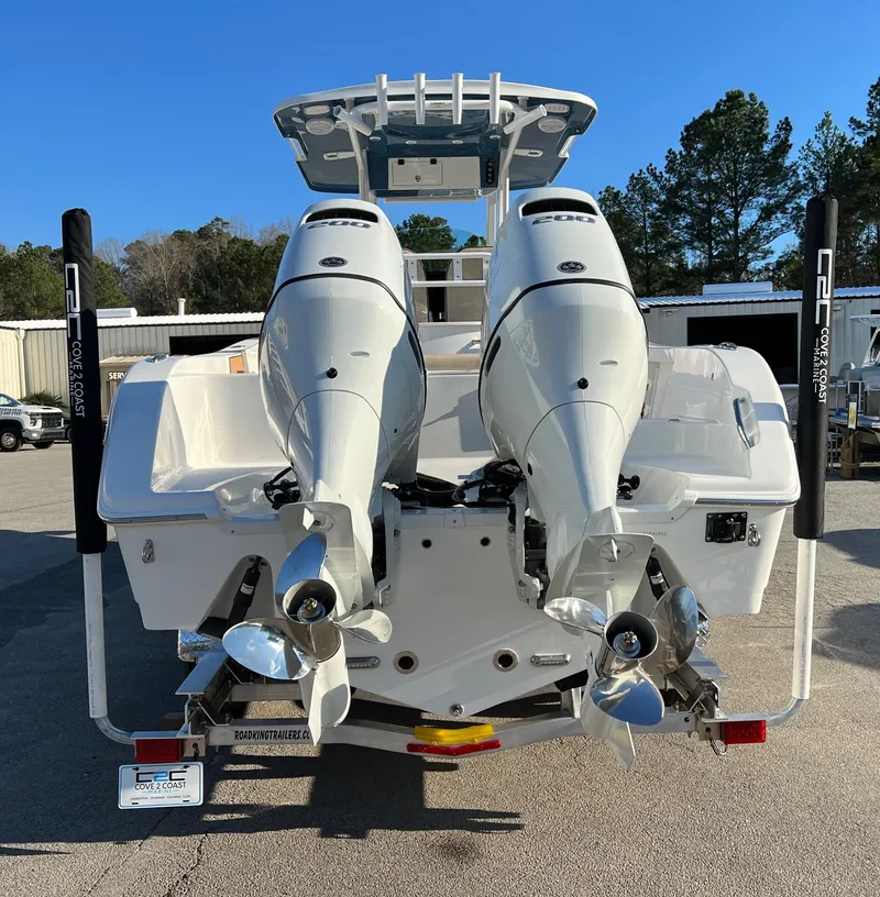 Slide: The Image of 2022 Sea Pro 259 Deep V Series CC boat with dual outboard motors, rear view. - 20