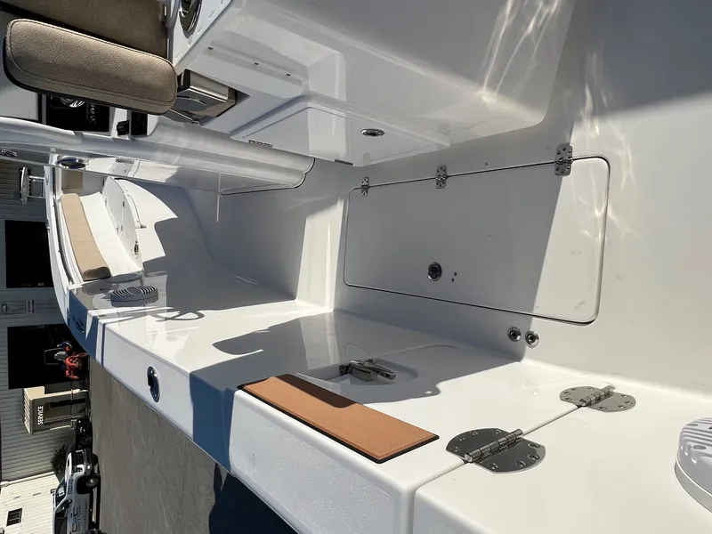 Slide: The Image of 2022 Sea Pro 259 Deep V Series CC boat interior with seating and storage compartments. - 8